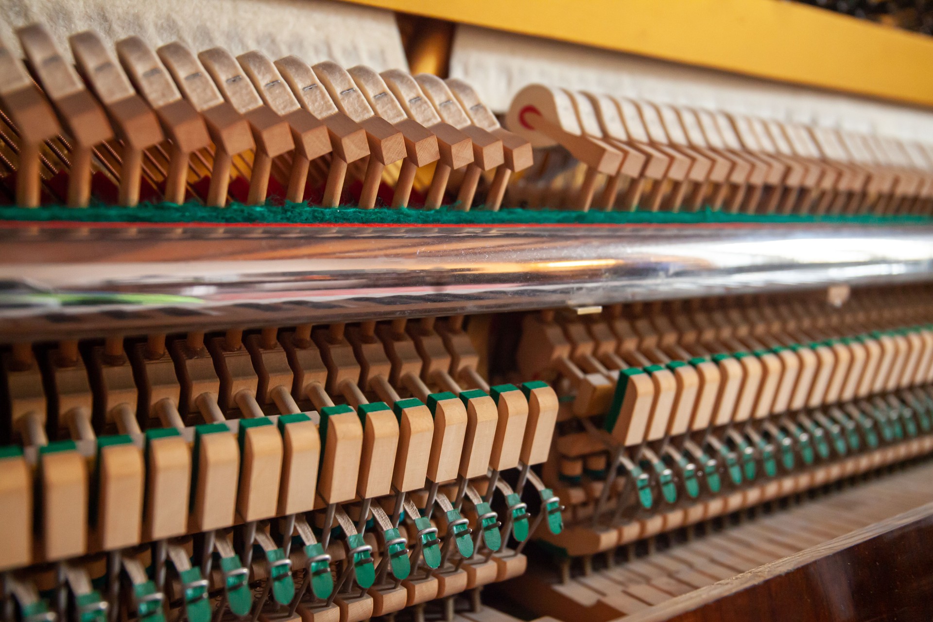 Open upright piano. Piano action close up. German piano action, internal mechanism. Piano tuning, repair and maintenance. Hammers.